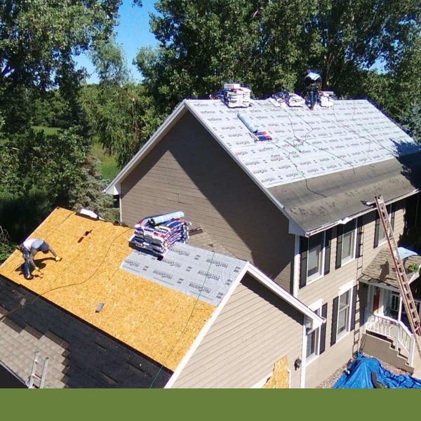Drone view of two homes during a roofing installation Drone view of two homes during a roofing installation