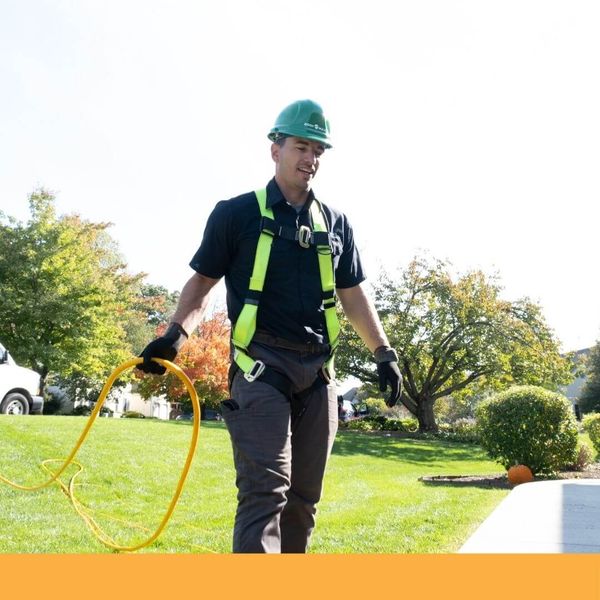 Guaranteed roof employee preparing to wash a roof