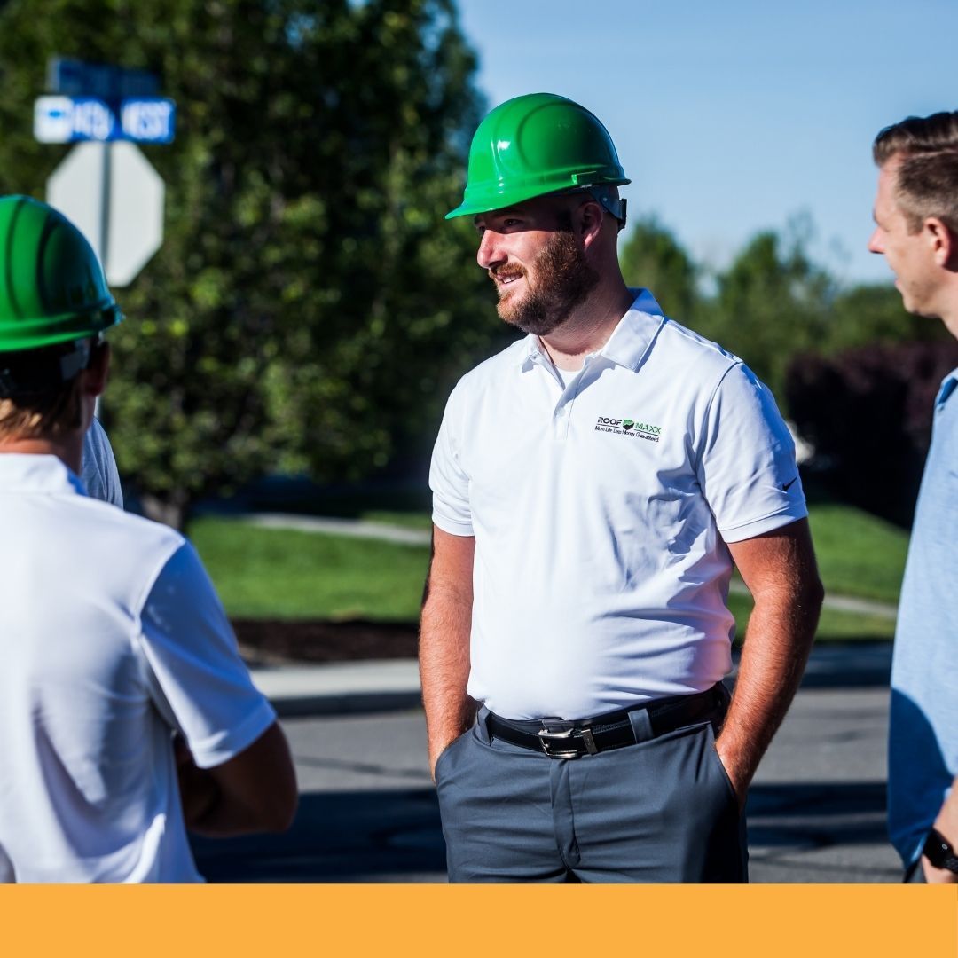roofing contractors standing outside working with team members