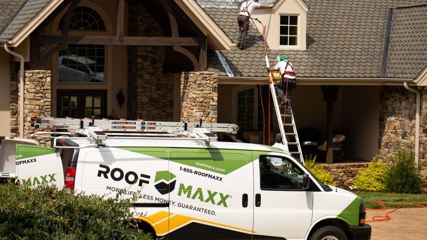Roof maxx truck in front of house Roof maxx truck in front of house