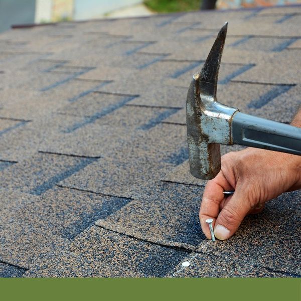 roofer working on roof shingles