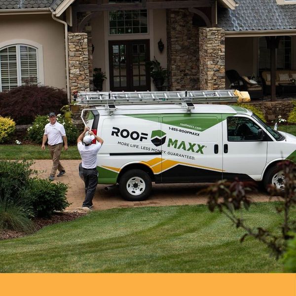 Roof Maxx van in front of a home