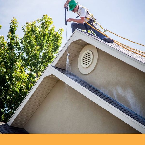 roofing contractor completing a roof cleaning