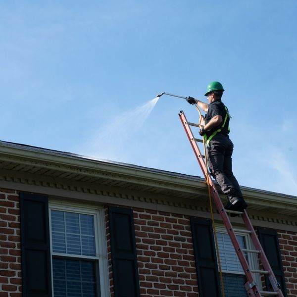 roofer applying roof shampoo