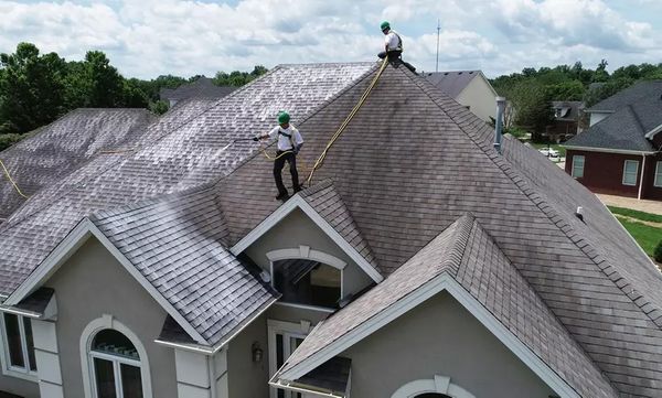 Guaranteed Roof workers sealing a roof