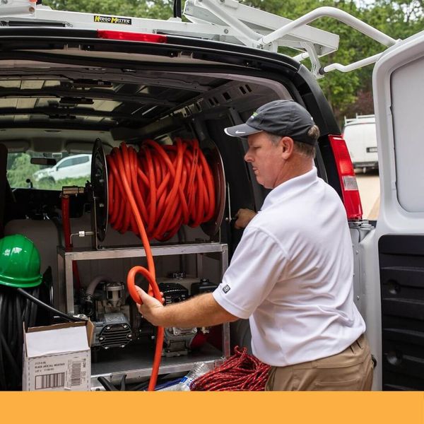 Guaranteed Roof employee preparing for a roof application