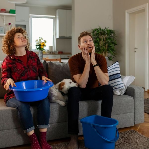 people on couch with buckets