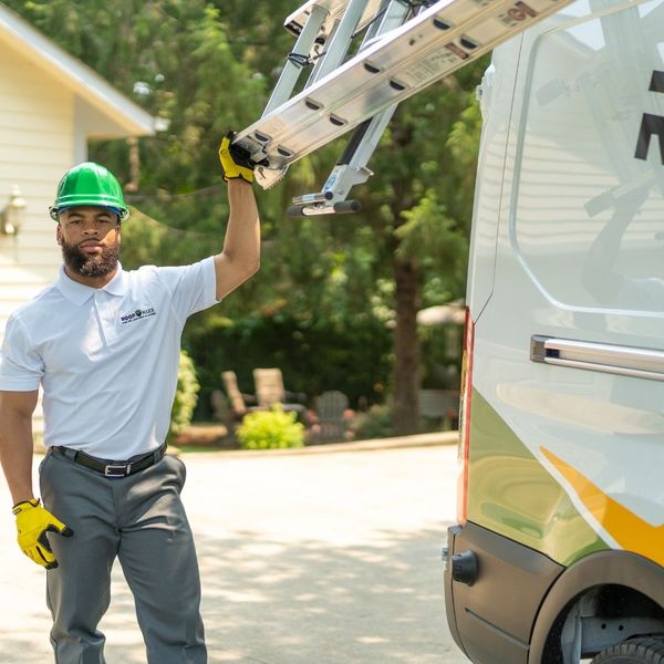 Roof Maxx employee getting the ladder off of the truck