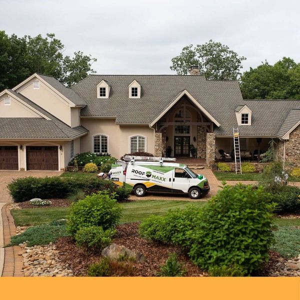 Roof Maxx van in front of a house
