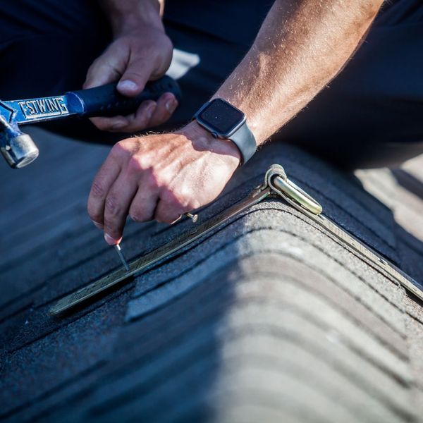 roofer nailing shingles on the roof roofer nailing shingles on the roof