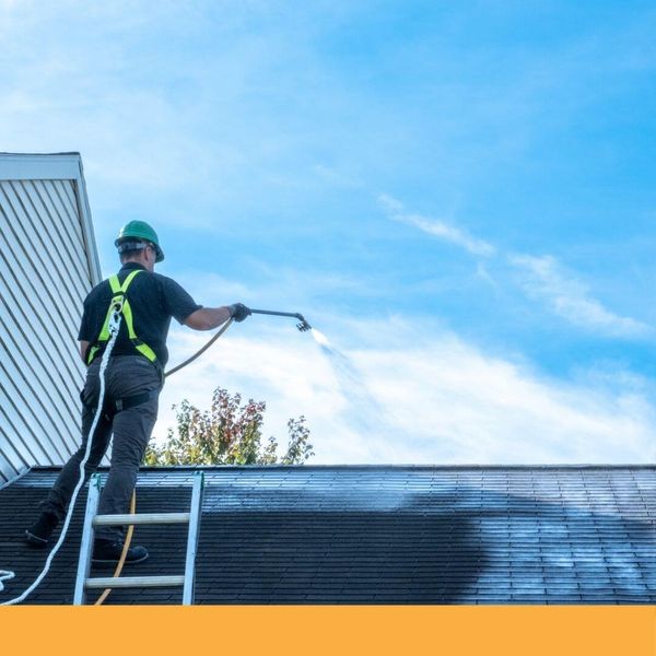 Guaranteed Roof employee applying Roof Shampoo