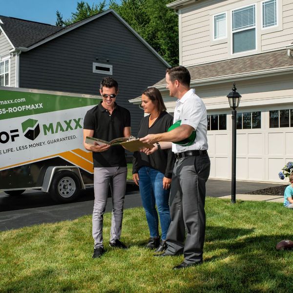 Roofer talking to the homeowners