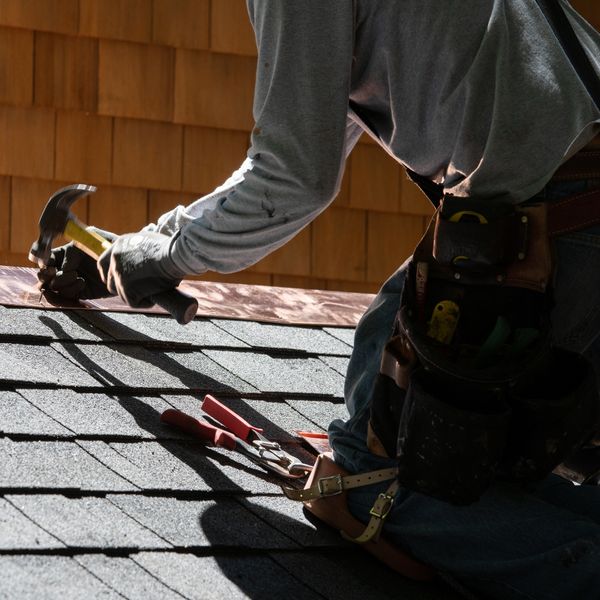 man repairing roof