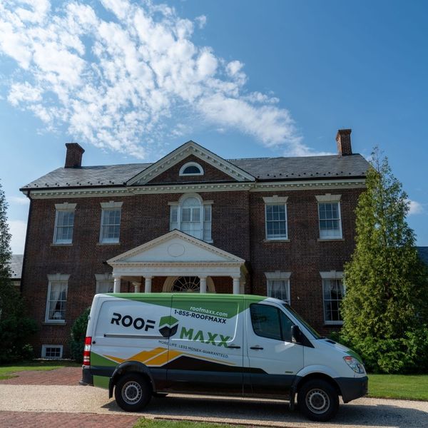 Roof Maxx van in front of a home