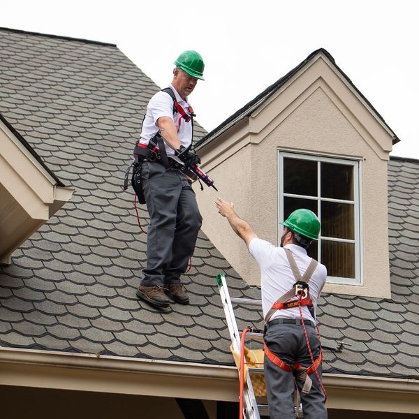 Two men working on roof