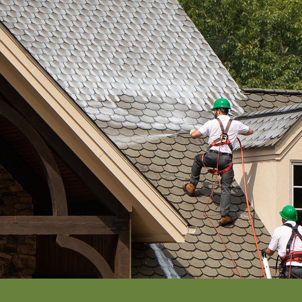 Men applying roof rejuvenation treatment