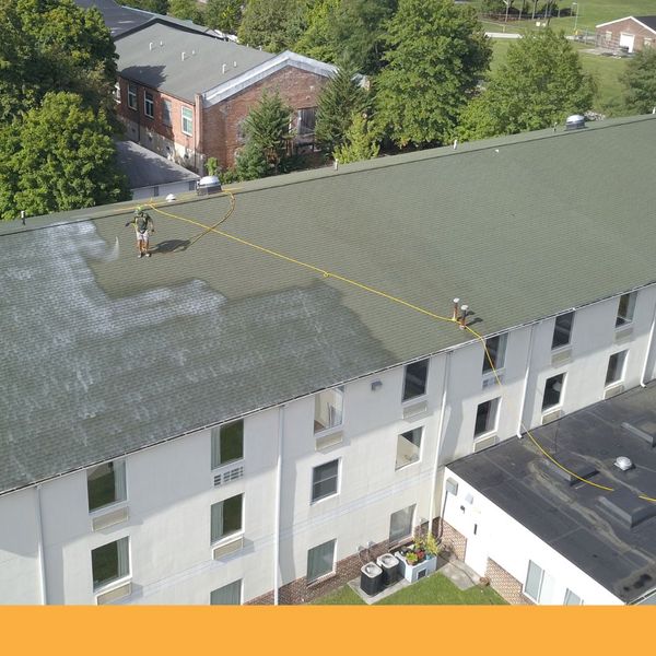 Aerial view of roofers installing shingles on a commercial building Aerial view of roofers installing shingles on a commercial building