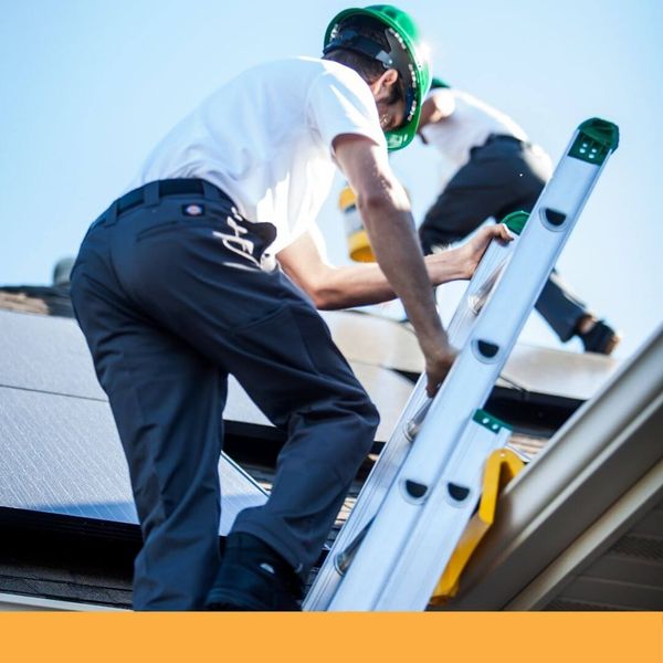 roofer climbing a ladder on to a roof