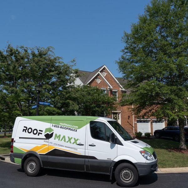 Roof Maxx Truck outside of a home