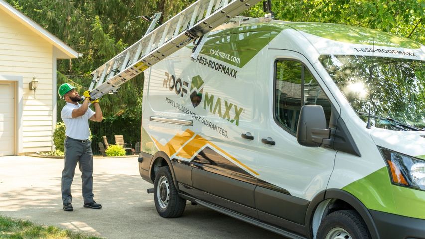 Guaranteed Roof working getting the ladder off of the van Guaranteed Roof working getting the ladder off of the van