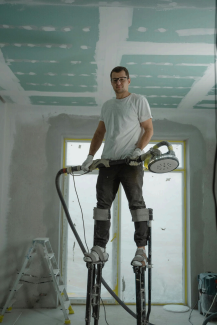 Image of a man working on a house