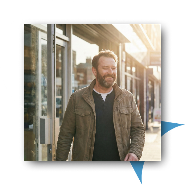 Man leaving a building smiling