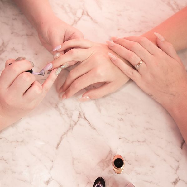 Top view of a woman getting her nails done