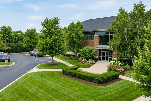 Professional commercial landscaping and grounds maintenance at an office building.