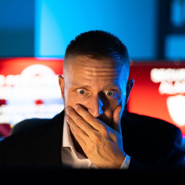 Man scared looking at computer screen