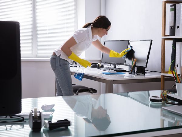 Lady cleaning screen in office