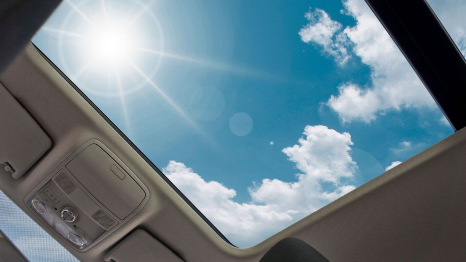 A sunny sky visible through a car's sunroof