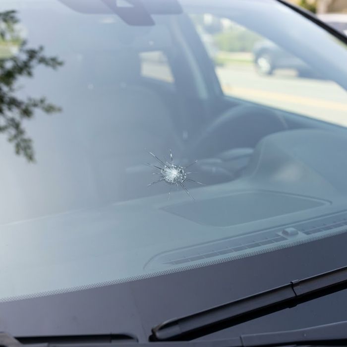 Small rock chip on a clear car windshield.