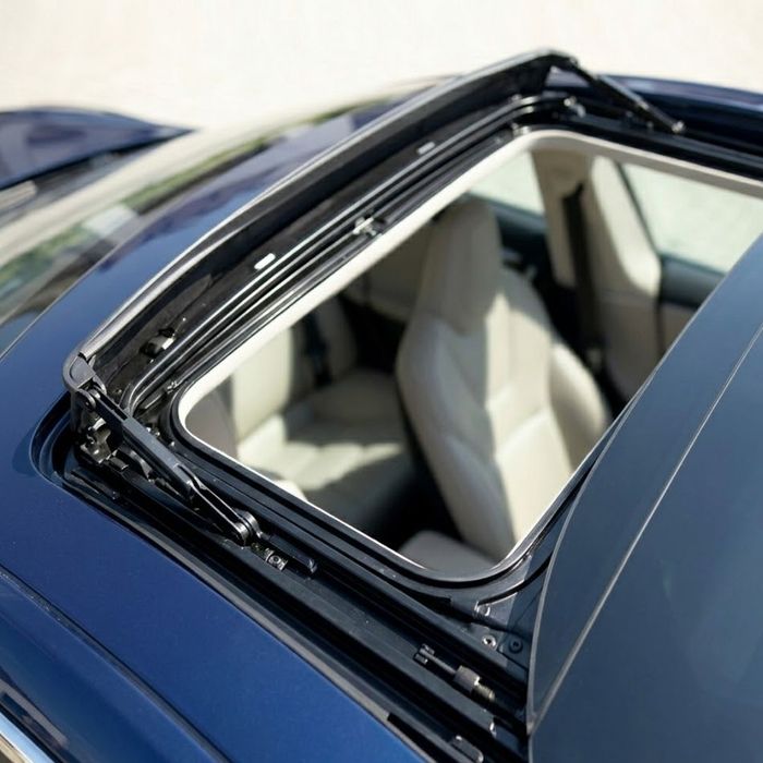 top-down exterior photo captures the intricate, clean tracks and mechanical parts of an open sunroof