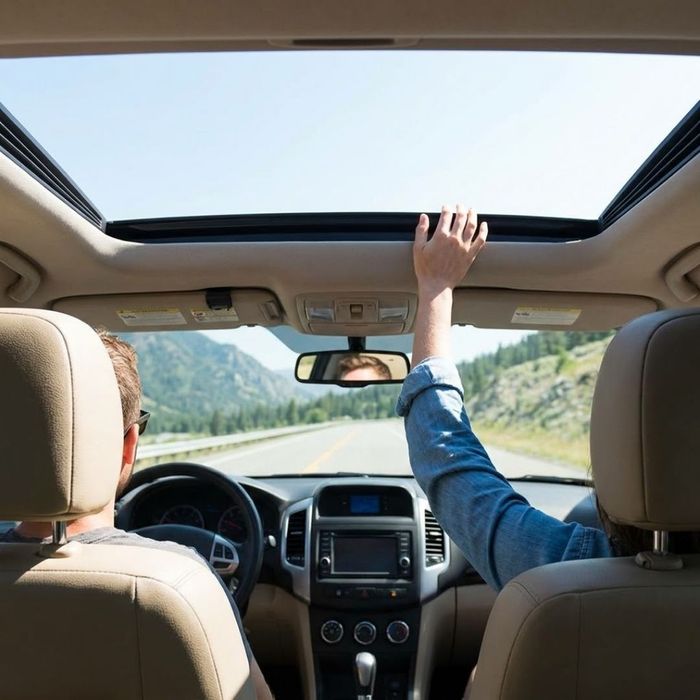 A panoramic view inside a modern SUV showcasing natural light streaming through the sunroof.