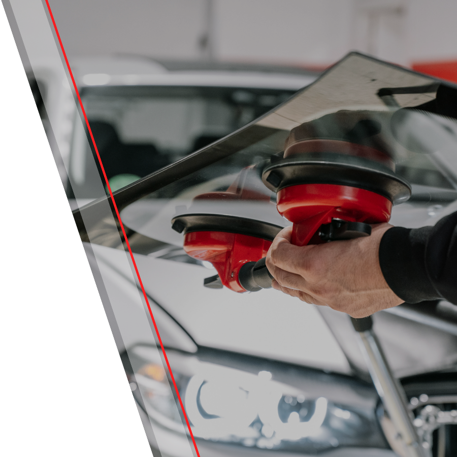 Auto glass technician working with a glass panel