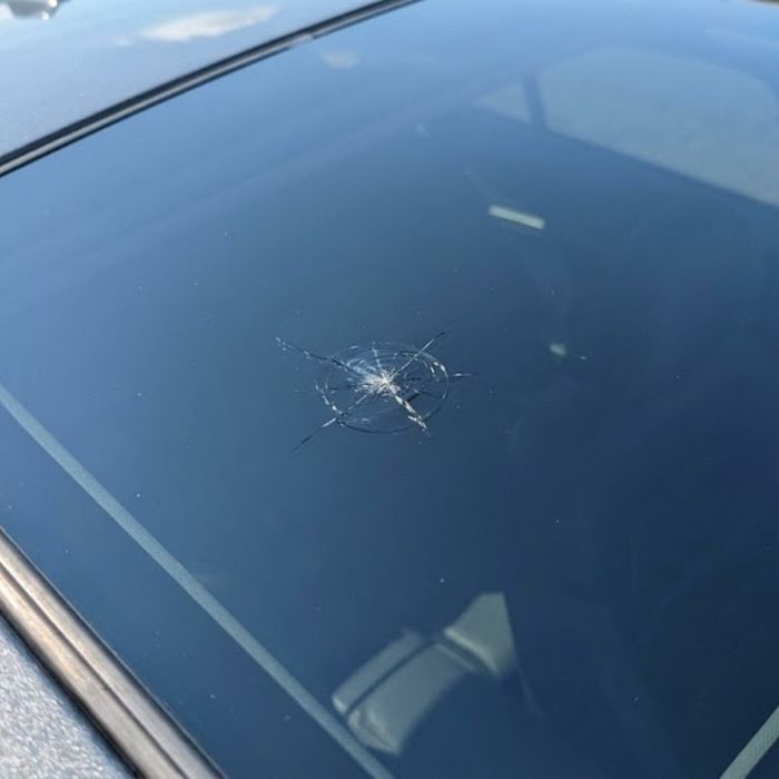 A car sunroof with a small crack in the glass