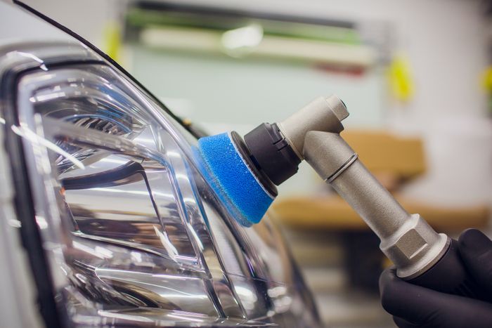 A headlight being polished