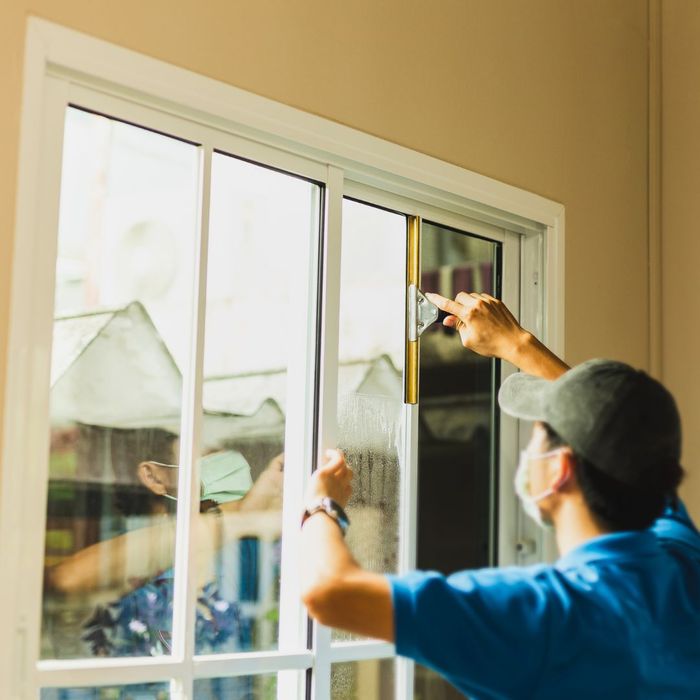 worker fixing house windows