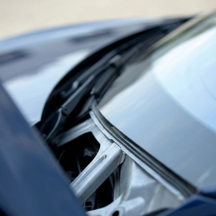 close-up showing the crucial bond where a car's windshield meets the structural A-pillar, ensuring stability.