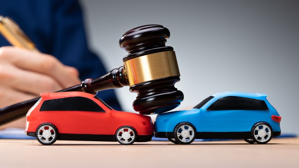 Gavel resting on toy cars