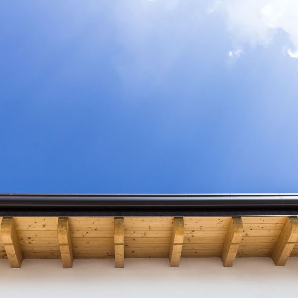 Cleaned gutters against a blue, sunny sky. 