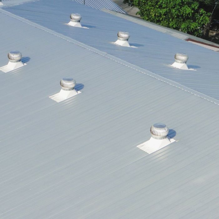 large metal commercial roof with vents