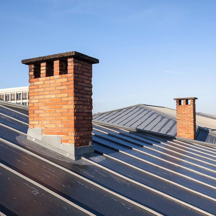 metal roof with brick chimneys