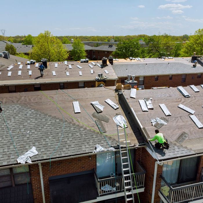 repairing roof on several apartment buildings