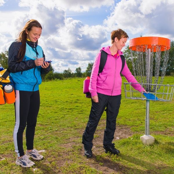 two women playing frisbee golf