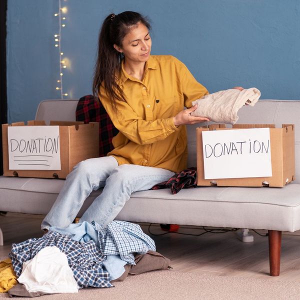 woman going through clothes to donate