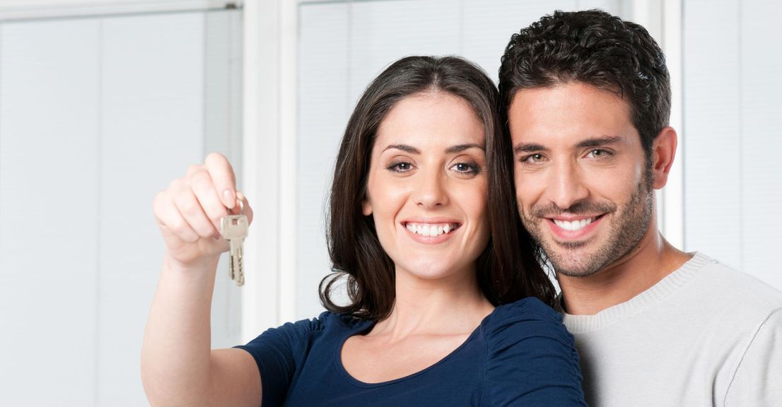 A happy couple holding apartment keys