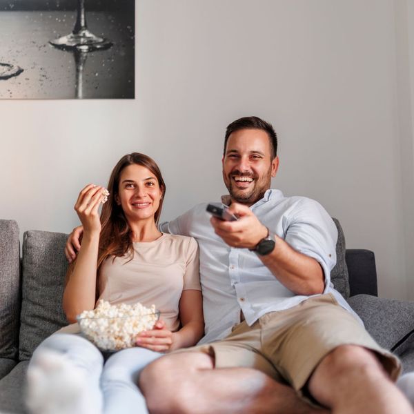 man and woman watching tv