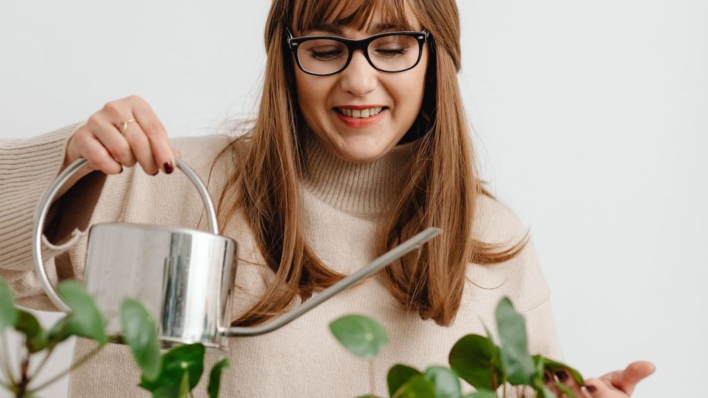 woman watering her apartment plants