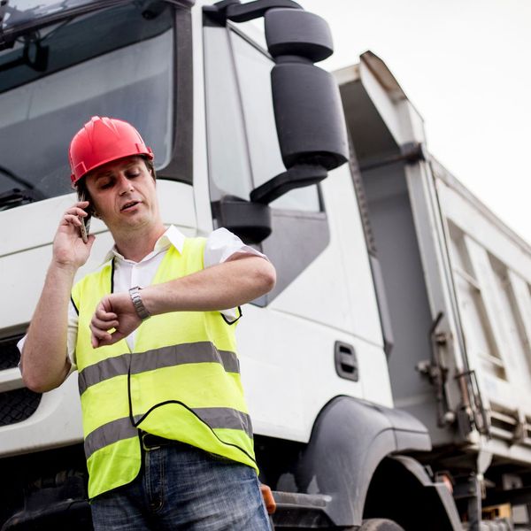 man on phone in front of a truck